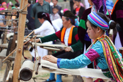 Hmong artisan hand-weaving linen in Sapa at Belle Maison Sapa Resort & Spa cultural experience
